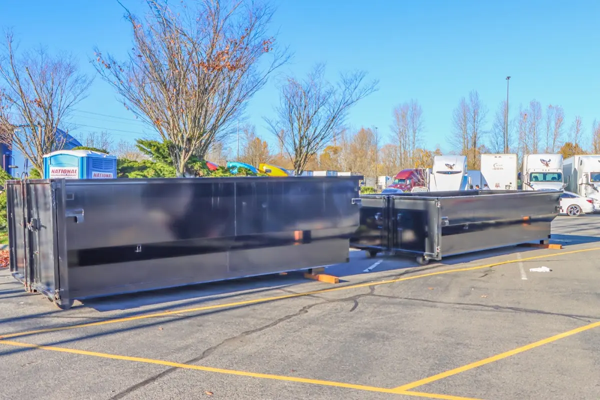 Professional dumpster rental service with roll-off container on residential driveway in Wilkins